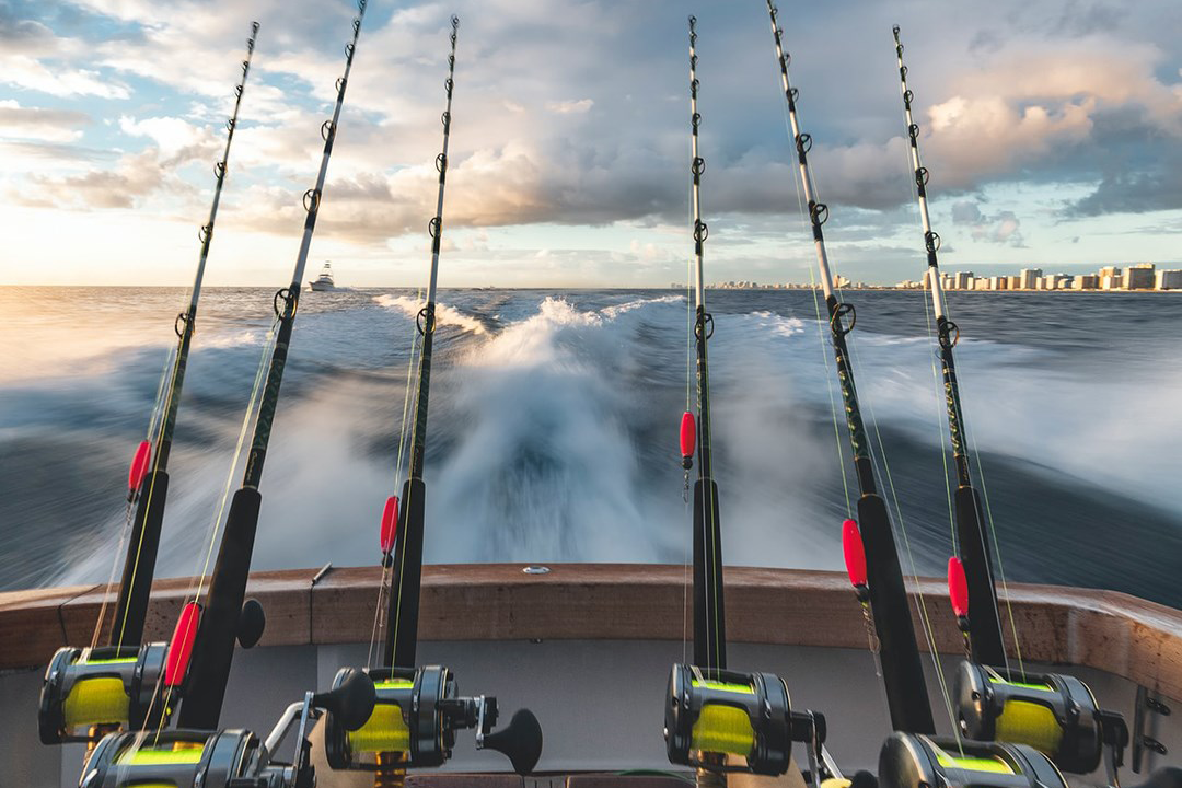 Boat driving offshore with multiple rods ready for fishing